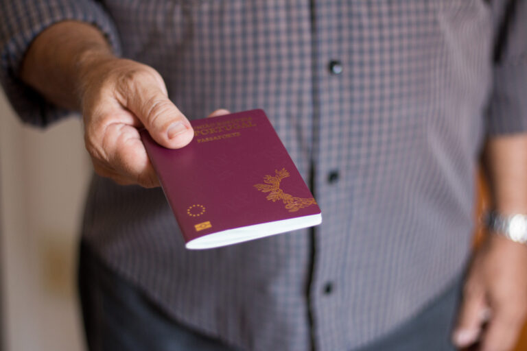 Man holding the Portuguese Passport by hand